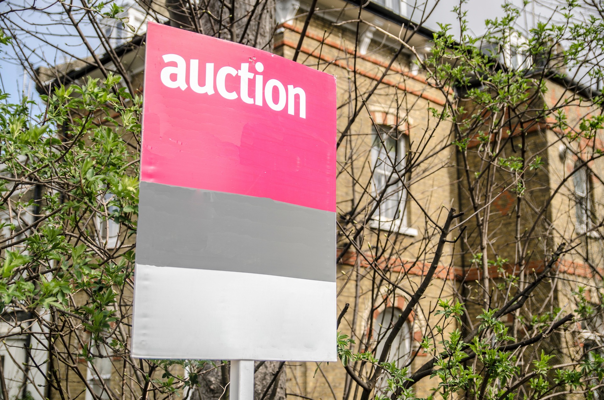 Auction sign with building background